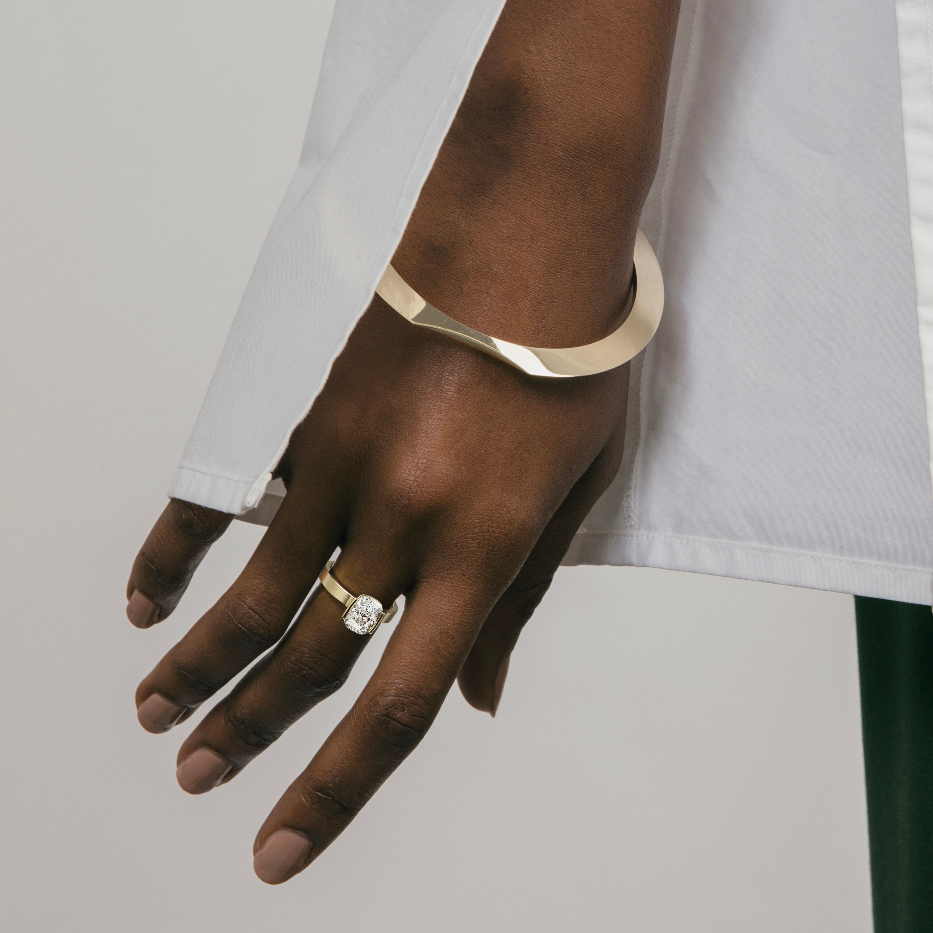 2.00 carat cushion diamond engagement ring in tapered partial bezel setting worn on hand