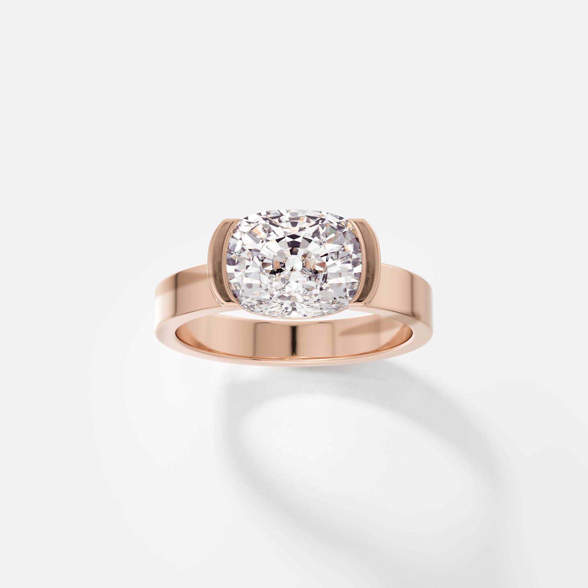 14k rose gold engagement ring with 2 carat cushion-cut diamond set east west in tapering partial bezel