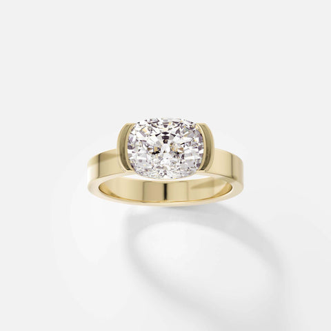 14k yellow gold engagement ring with 2.00 carat cushion-cut diamond set east-west in tapered partial bezel on wide flat band