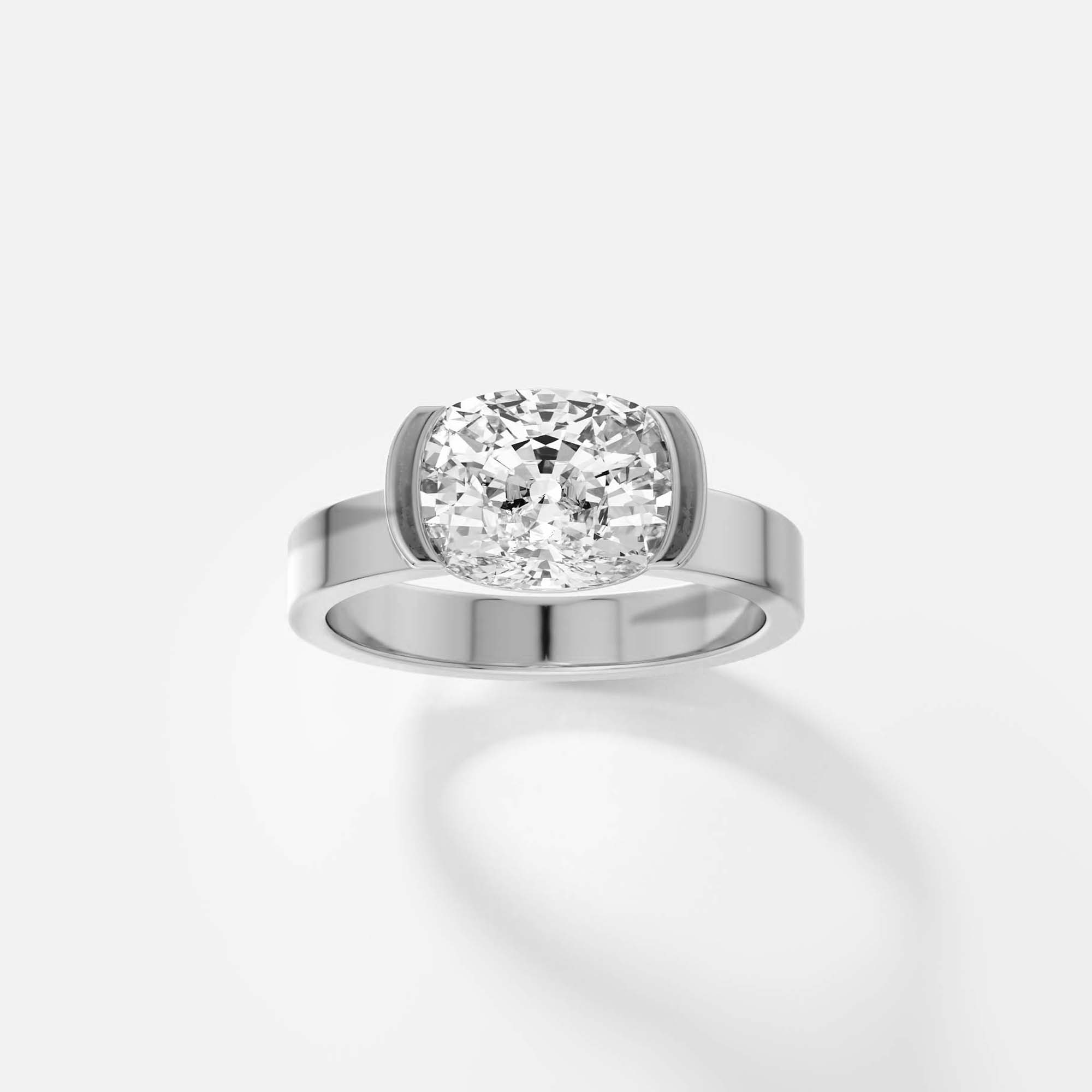 platinum engagement ring with 2.00 carat cushion diamond set east-west in tapered partial bezel on wide band