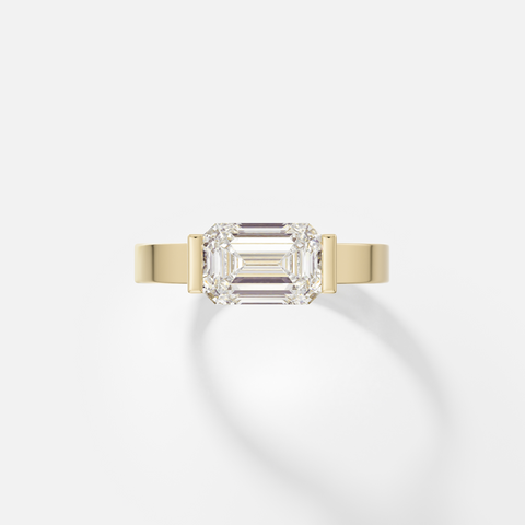Silvi east west emerald cut diamond partial bezel engagement ring front view in 14k yellow gold