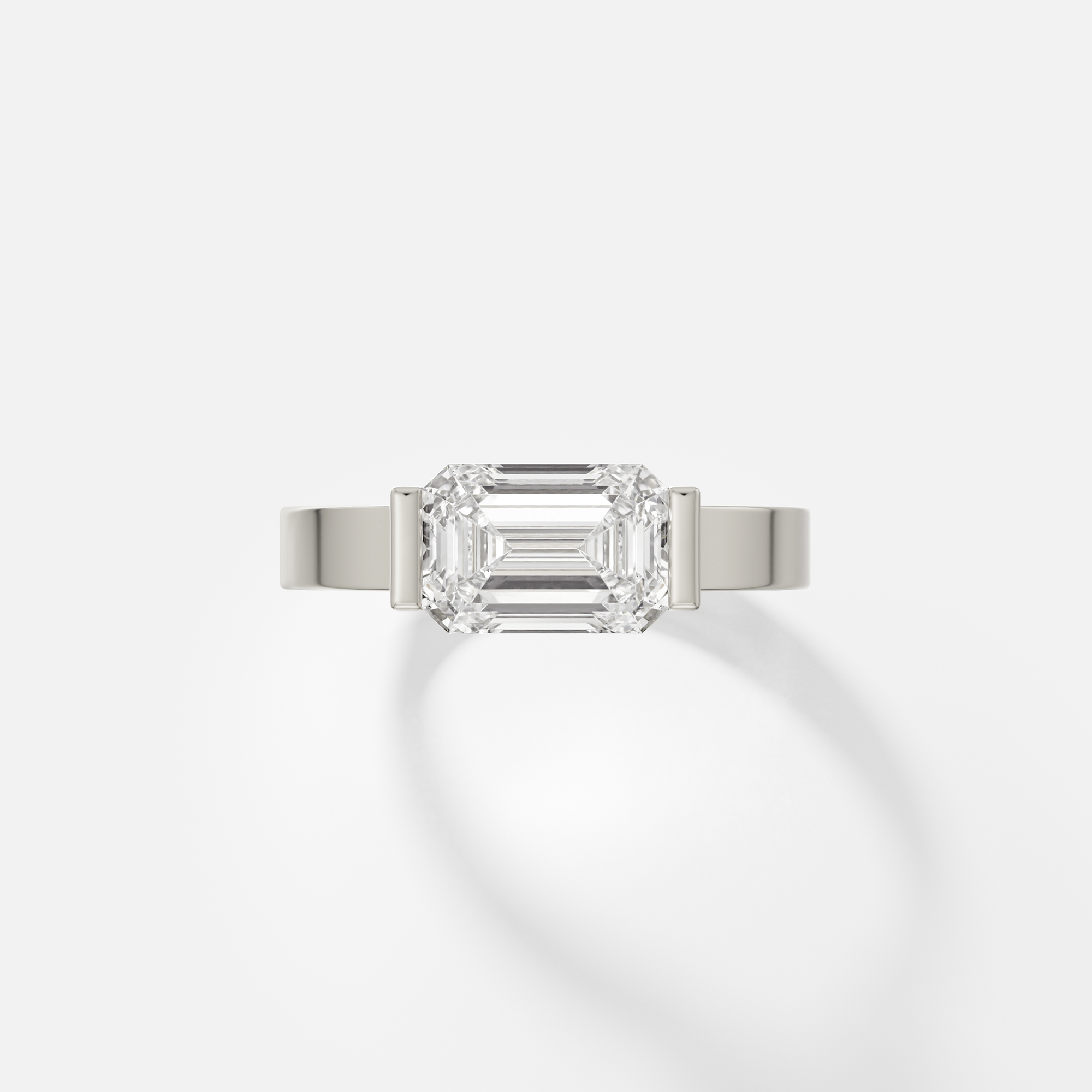 Silvi east west emerald cut diamond tapered bezel ring front view in 14k white gold