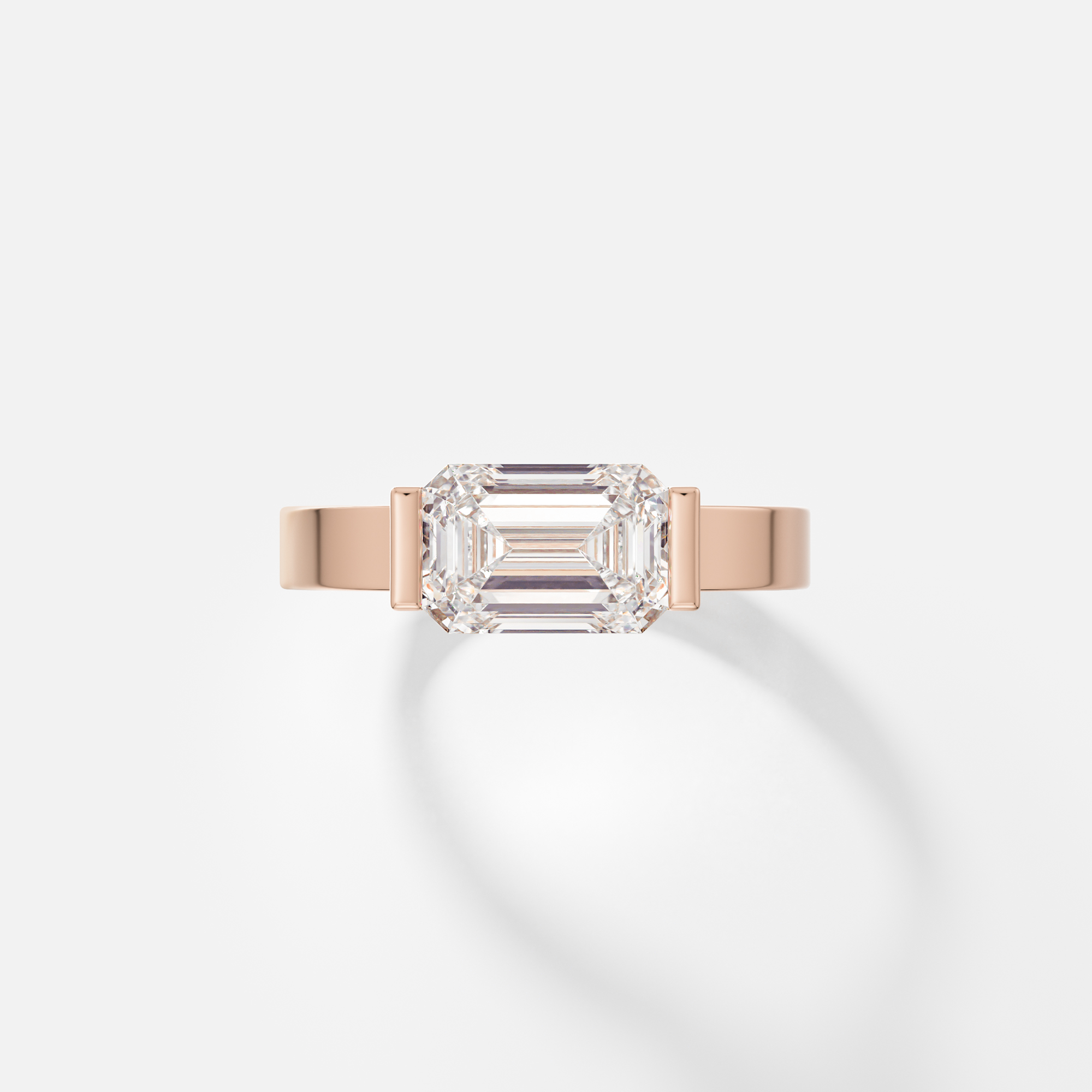 Silvi east west emerald diamond partial bezel engagement ring front view in 14k rose gold