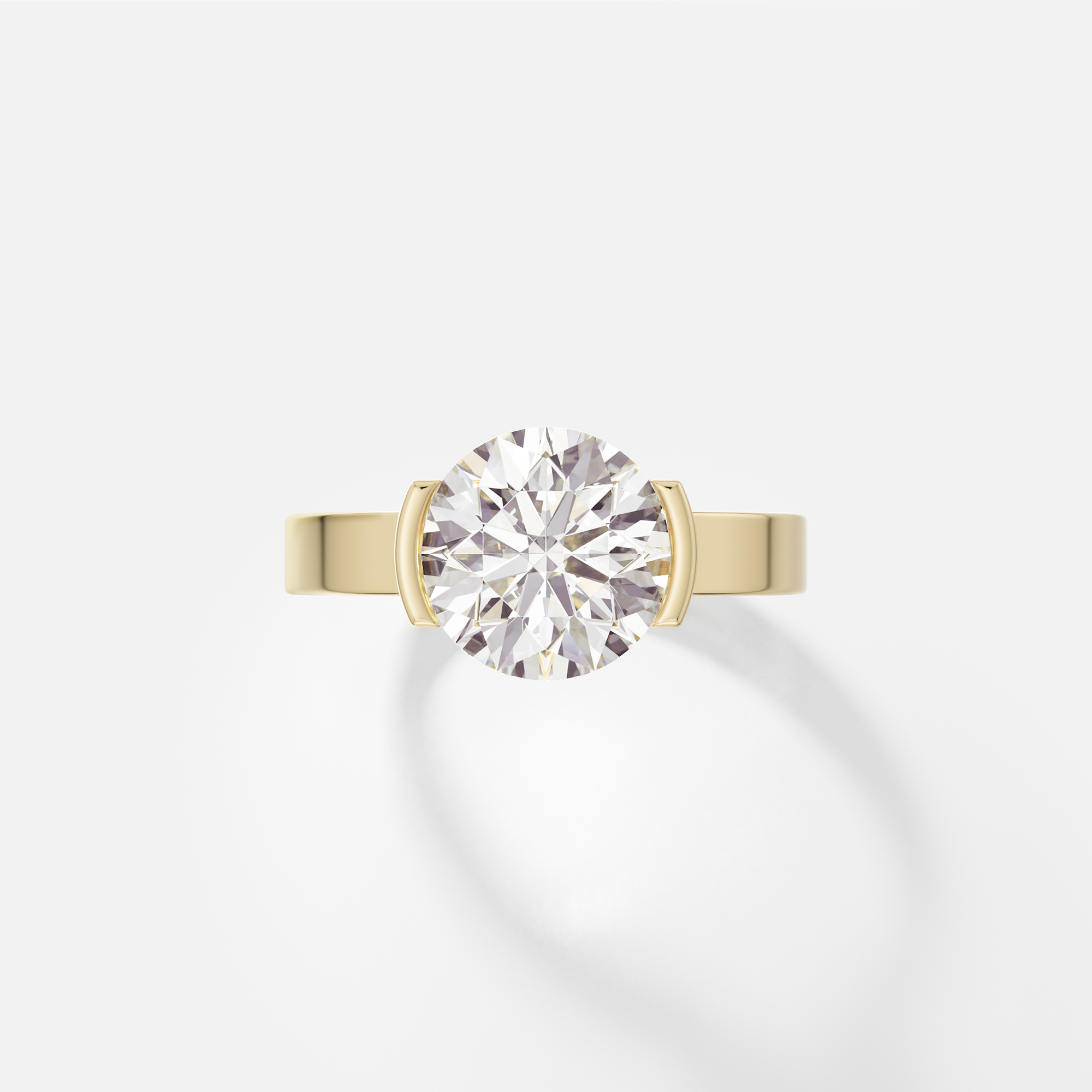 14k yellow gold engagement ring with 2.50 carat round brilliant diamond set in tapered partial bezel on wide flat band