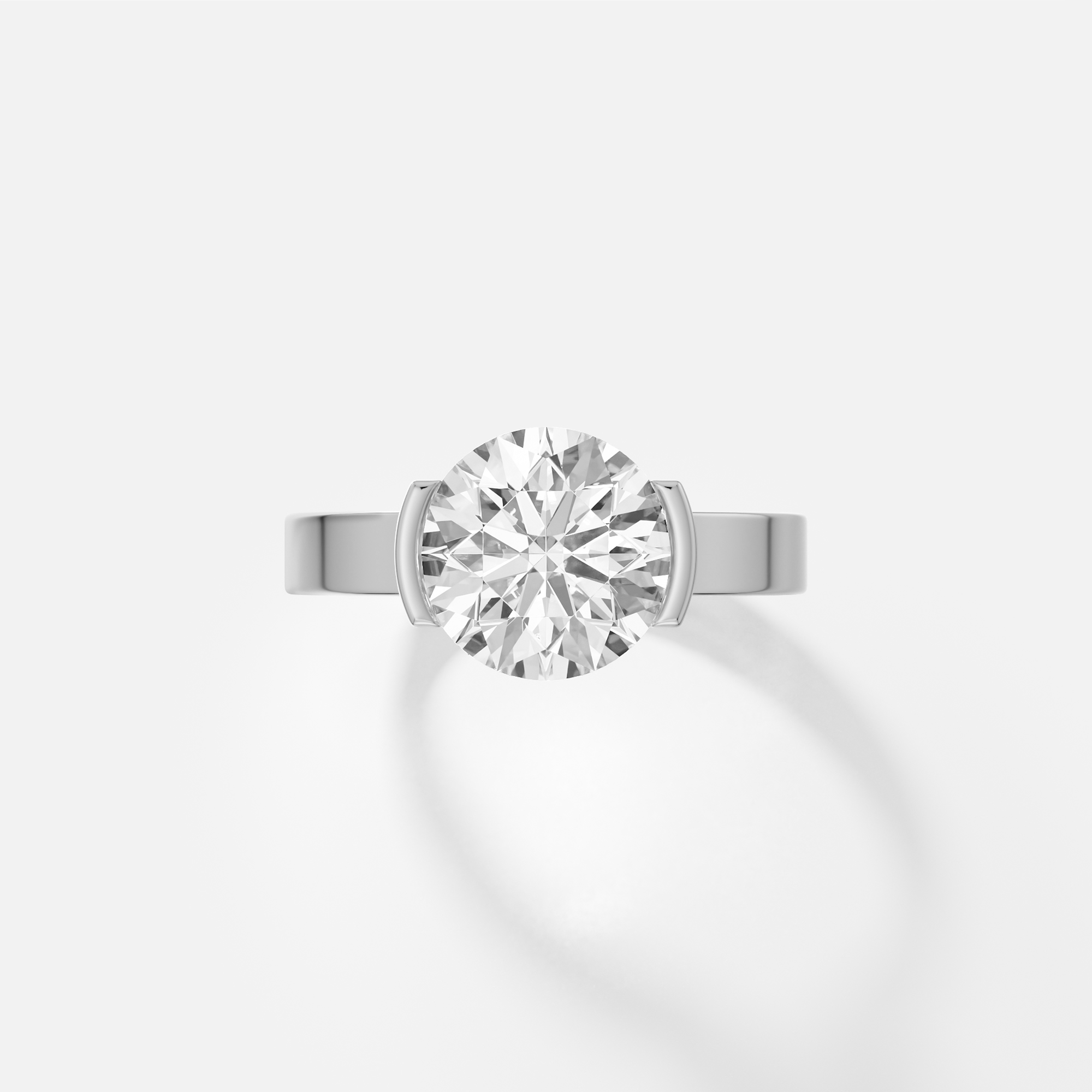 platinum engagement ring with 2.50 carat round brilliant-cut diamond set in tapered partial bezel on wide band