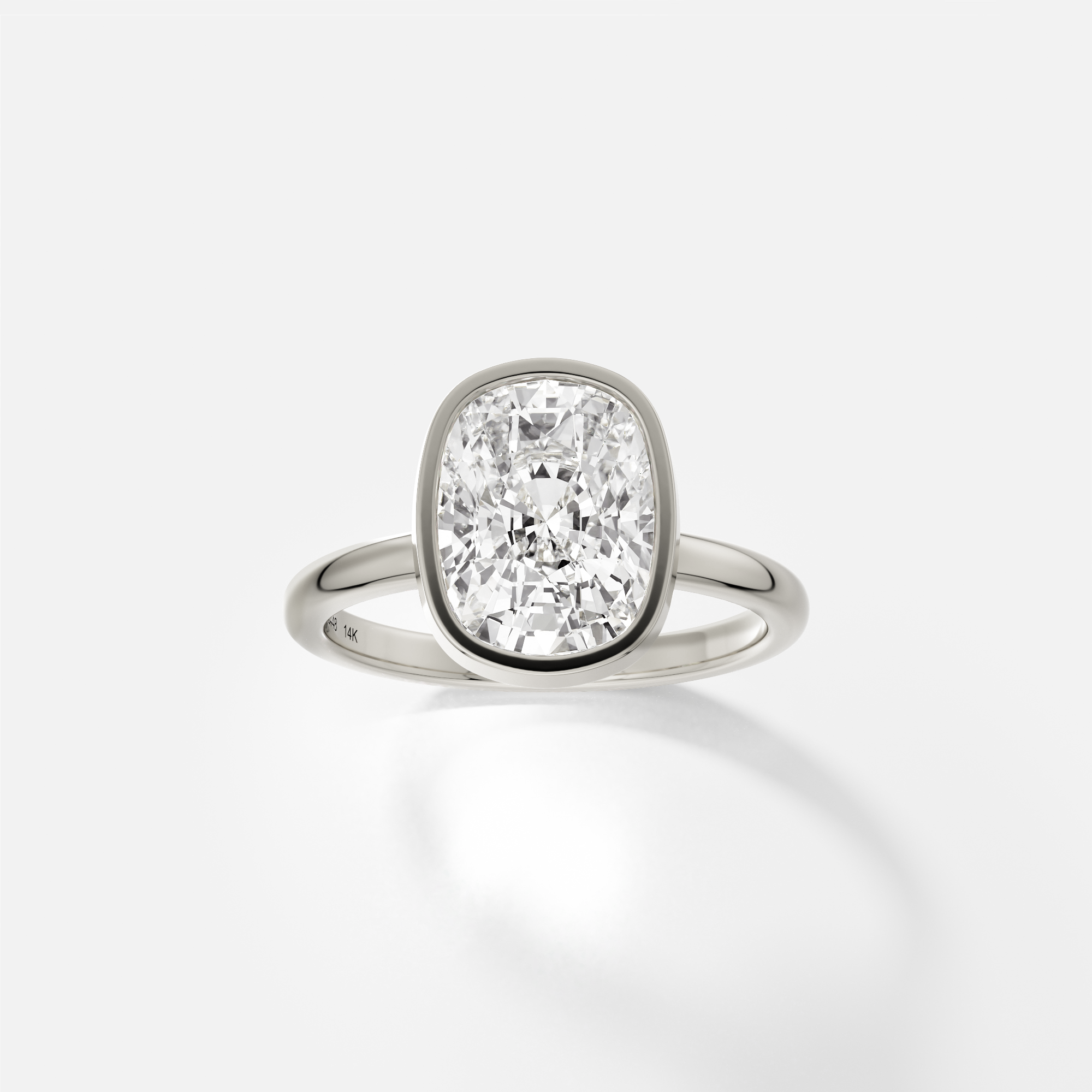 14k white gold engagement ring with 3.50 ct elongated cushion diamond in thin bezel setting on domed band