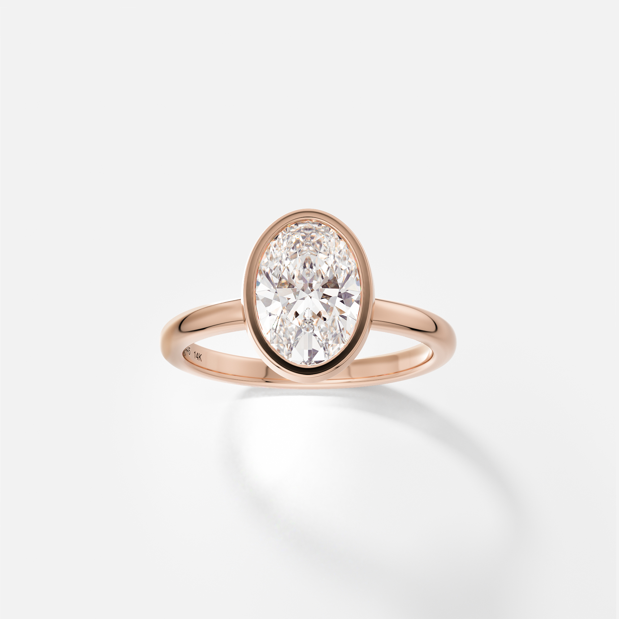 14k rose gold engagement ring with 1.50 carat oval diamond bezel set on 2mm domed band