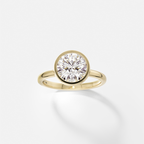 Syd round brilliant diamond thin bezel engagement ring angled side view