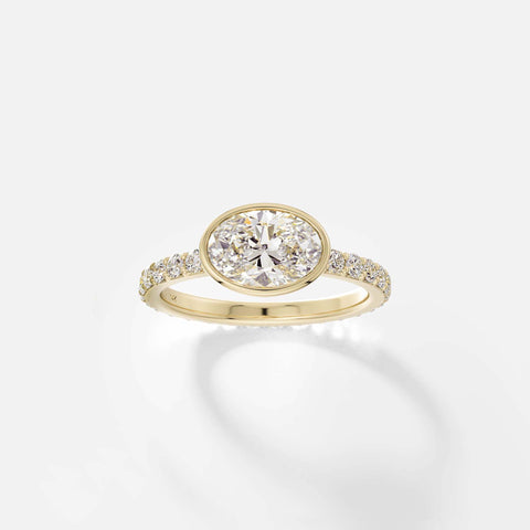 Tulpe east west oval diamond bezel pavé band ring front view in 14k yellow gold
