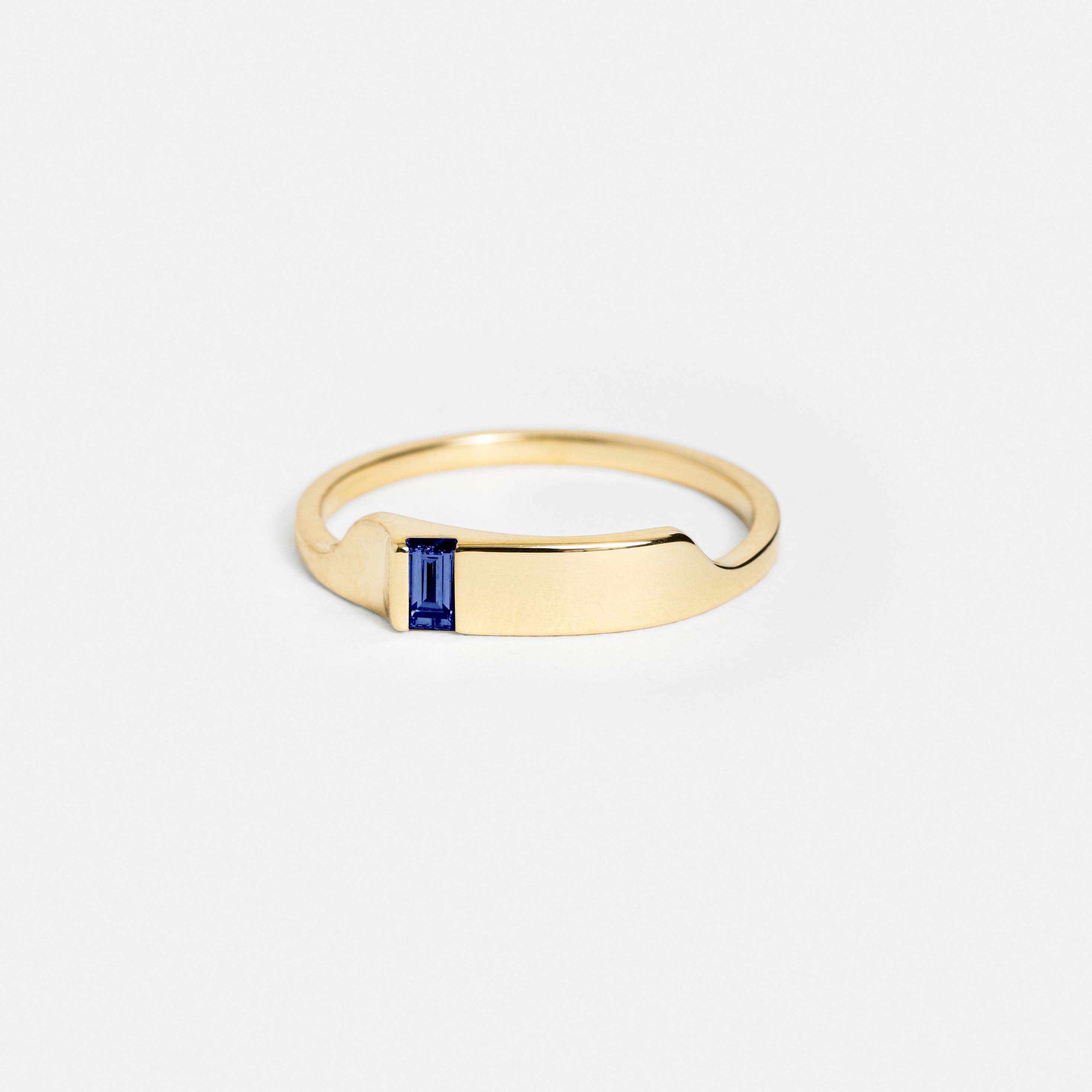 14k yellow gold thin ring with angular peak and baguette-cut blue sapphire