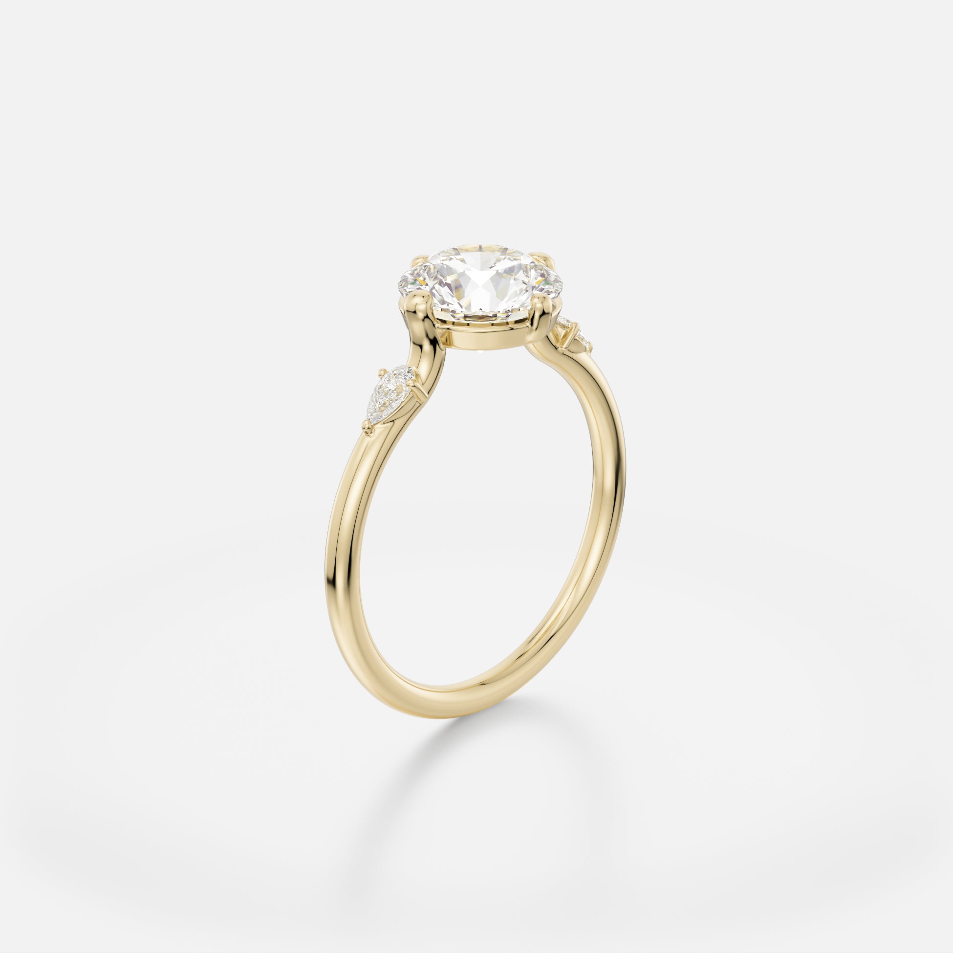 Veli three stone round brilliant diamond ring with pear accents angled side view
