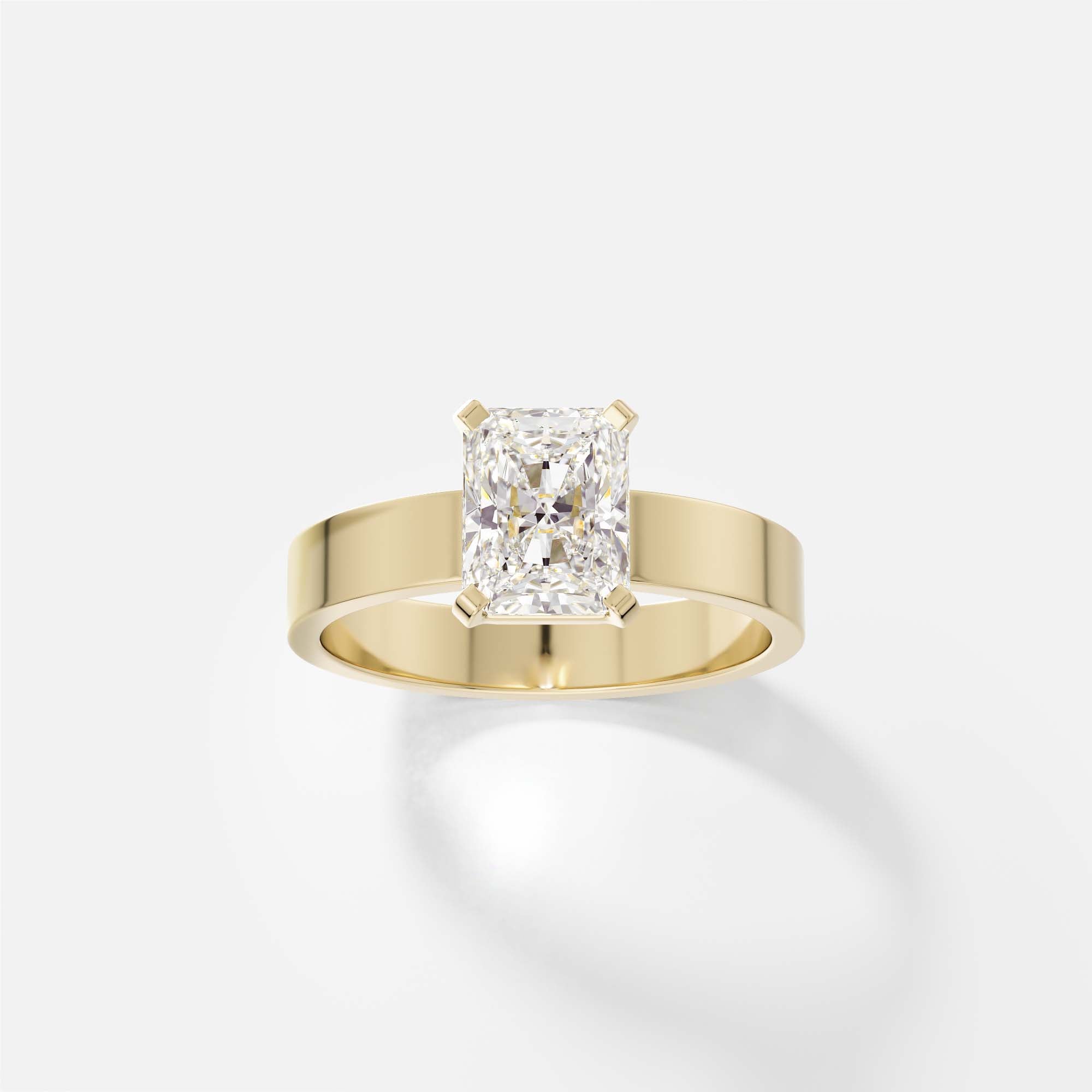 14k yellow gold engagement ring with 1.50 carat radiant-cut diamond set north south in corner prongs on flat profile band