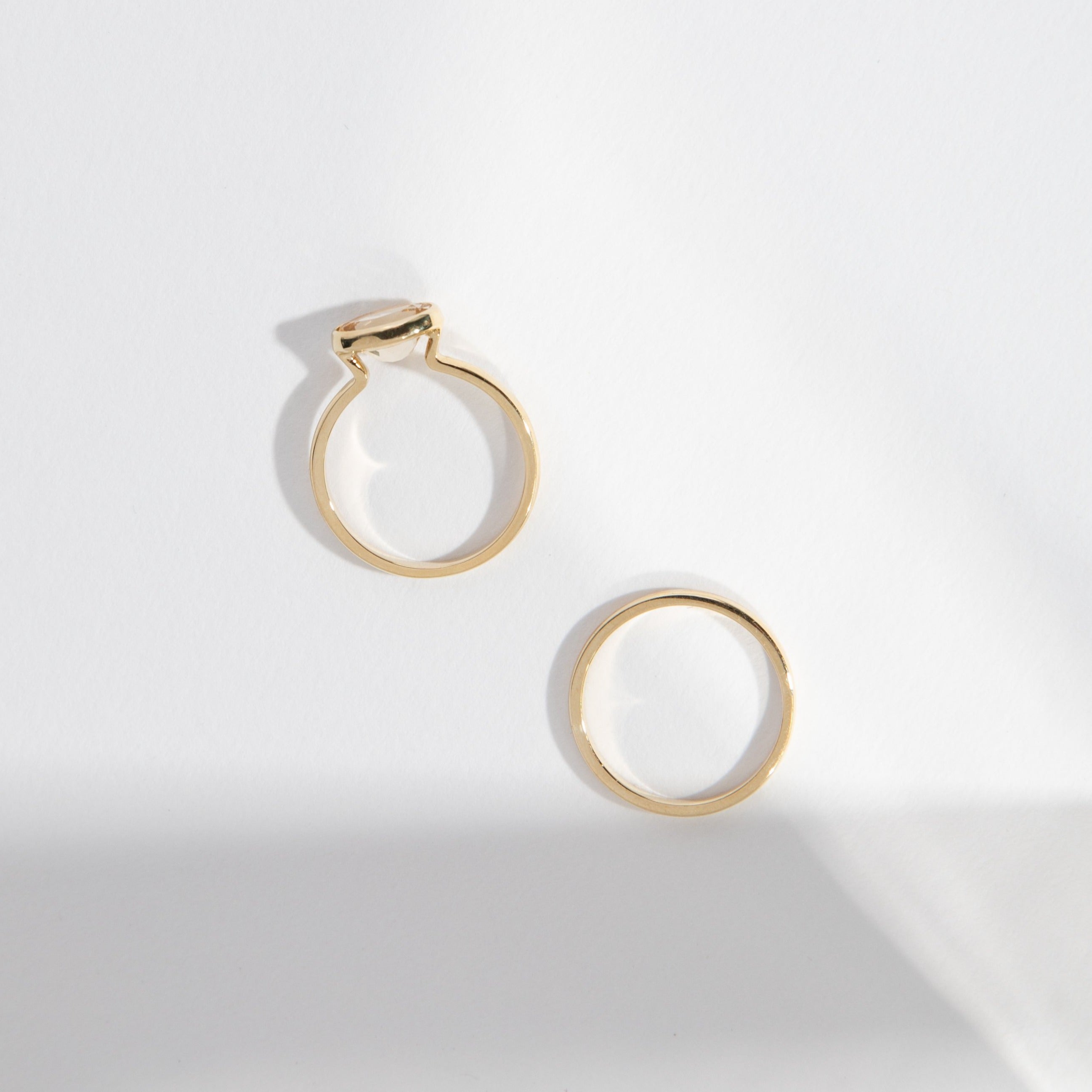 14k yellow gold domed wedding band shown beside engagement ring