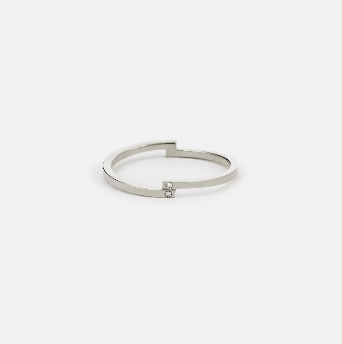 14k white gold delicate wedding band with asymmetrical diamond layout