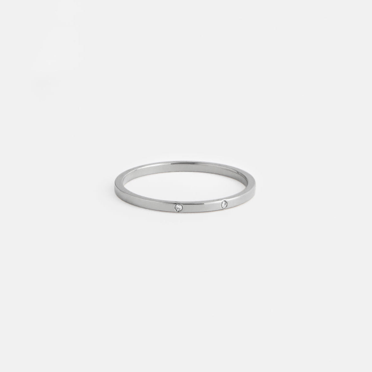 14k white gold delicate wedding band with two round white diamonds