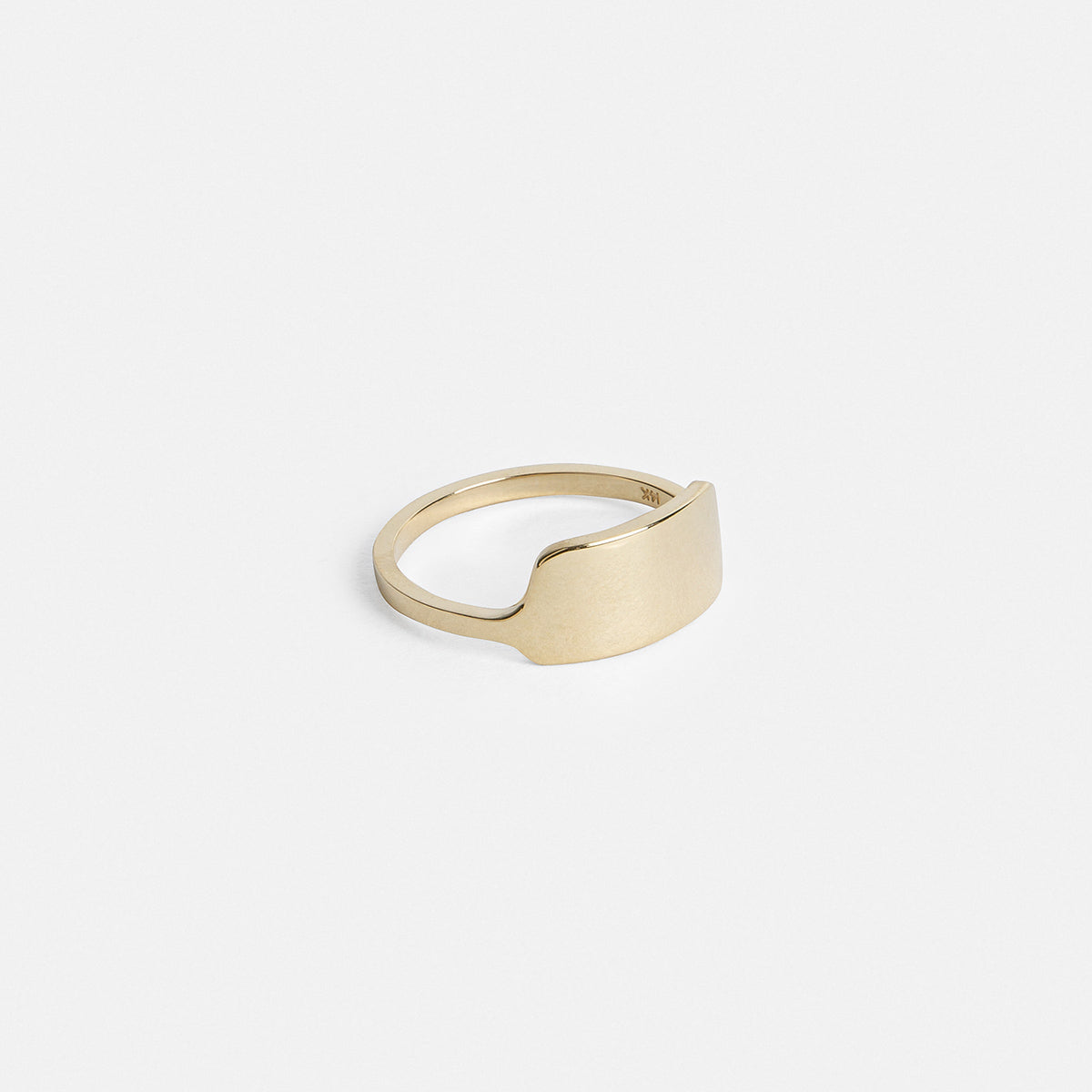 Solid gold band showing raised shield detail from the side