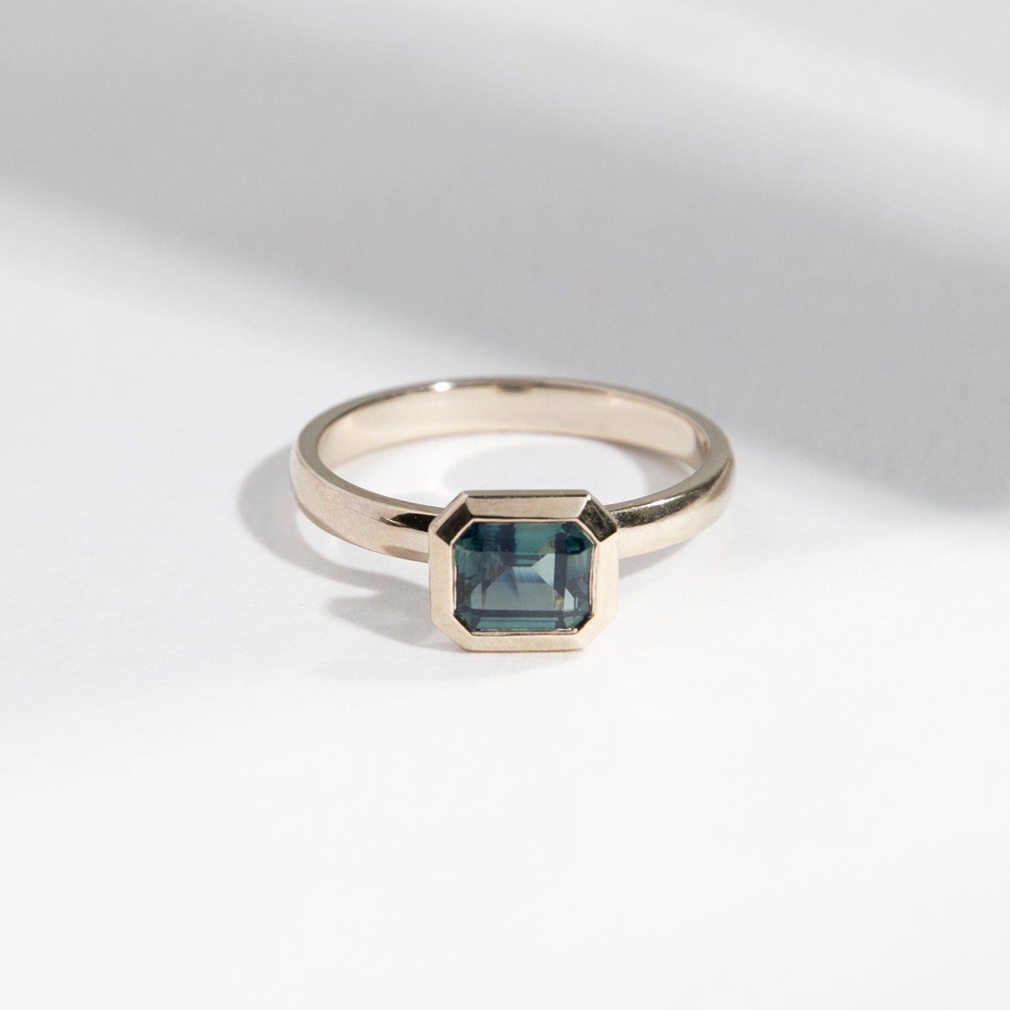 Vilke Handmade Ring in 14k White Gold set with a 0.91ct emerald cut teal sapphire By SHW Fine Jewelry NYC